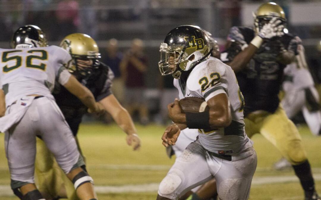 
Myrtle Beach’s Brandon Sinclair runs through a gap in the Conway defensive line for big yardage Friday.
