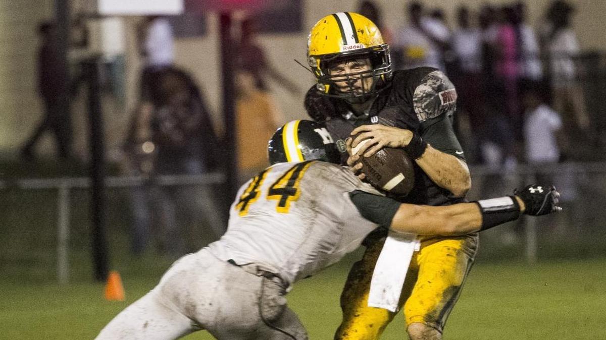 Myrtle Beach defensive end Sean McGonigal delivers a big hit to Conway quarterback Peyton Derrick during last Friday’s game.