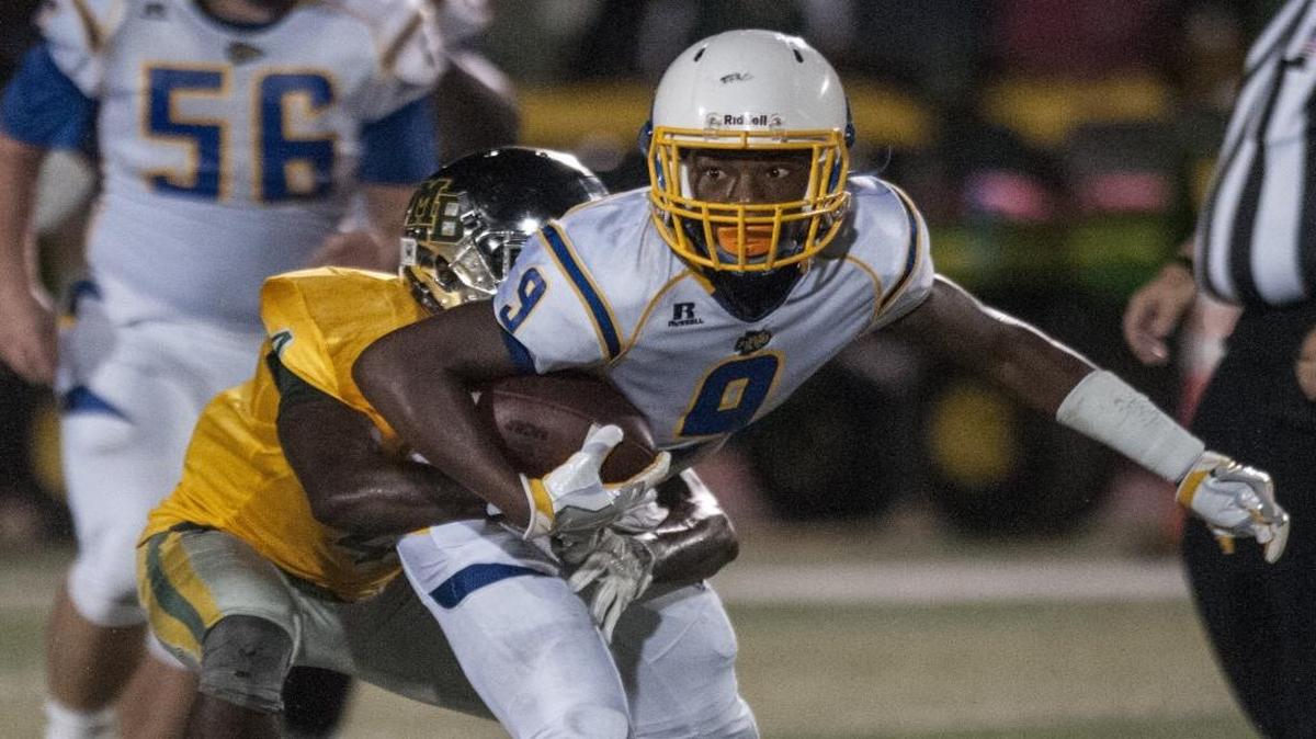 North Myrtle Beach’s Maurice Finch drags a Myrtle Beach defender during the meeting between the teams last month. The Region VII-4A rivals can both earn playoff berths this Friday night.