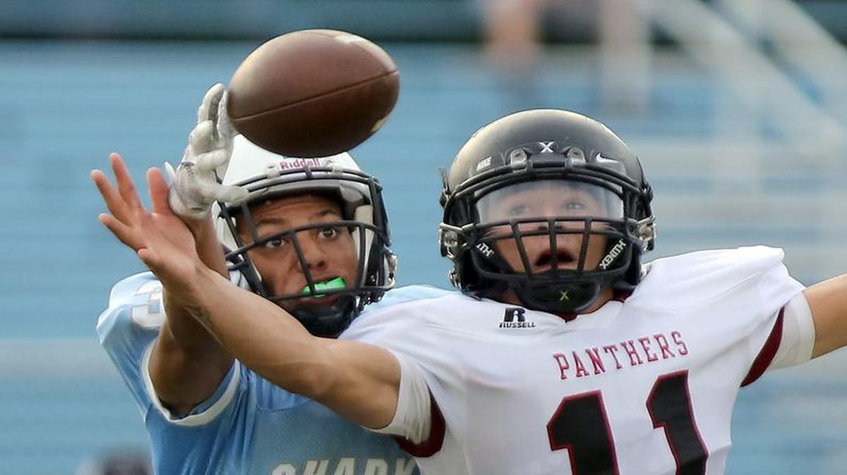 St. James’ Trey Myers and Carolina Forest’s Ismael Garcia go for a pass in the game at St. James on Thursday . The game was not complete at presstime. For more, check out myrtlebeachonline.com and see Saturday’s edition.