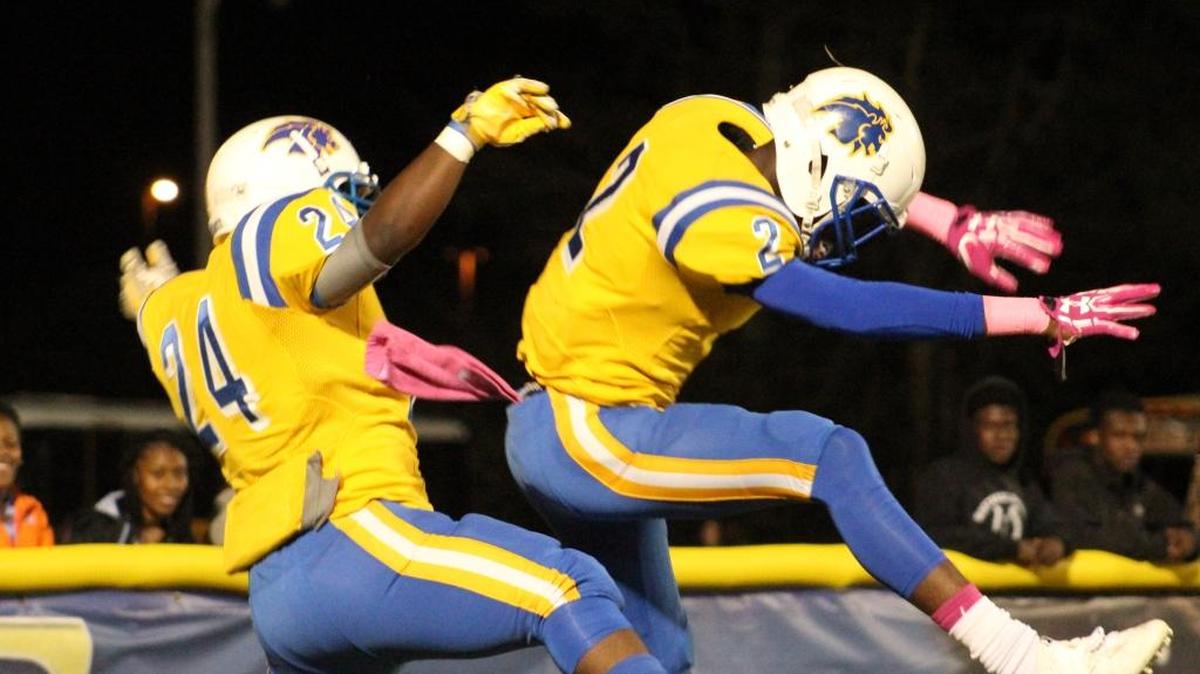Celebrating a Loris touchdown are Tyrek Williams (24) and James Walters (2) in the Lions 42-14 victory over Waccamaw.