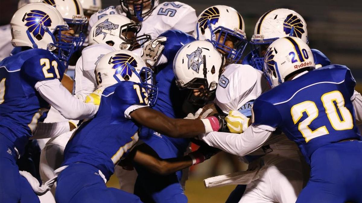 A host of North Myrtle Beach tacklers corral St. James running back Hunter Smiley during last Friday’s game in Little River.