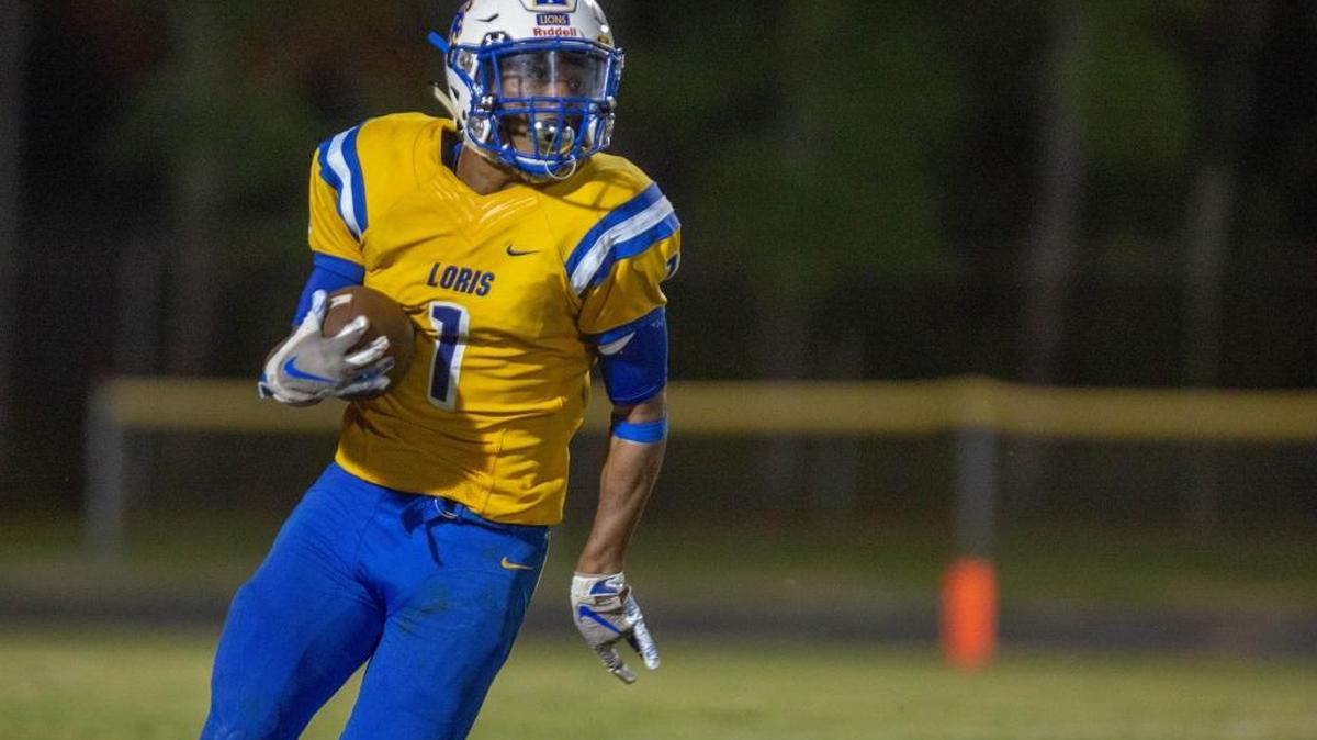Loris Lions running back Waderek Hemingway returns a punt against the St. James Sharks Friday night at Heniford Field in Loris.