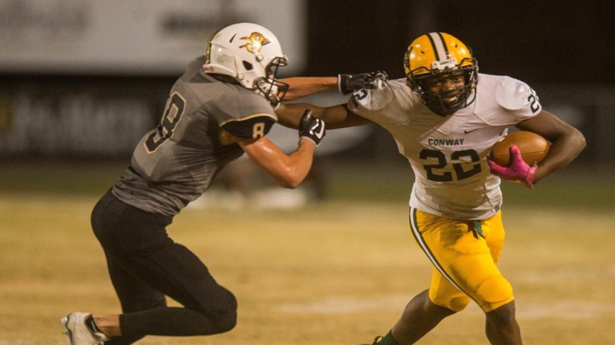 Conway’s Antonio Long tries to break a tackle against Socastee on Friday.