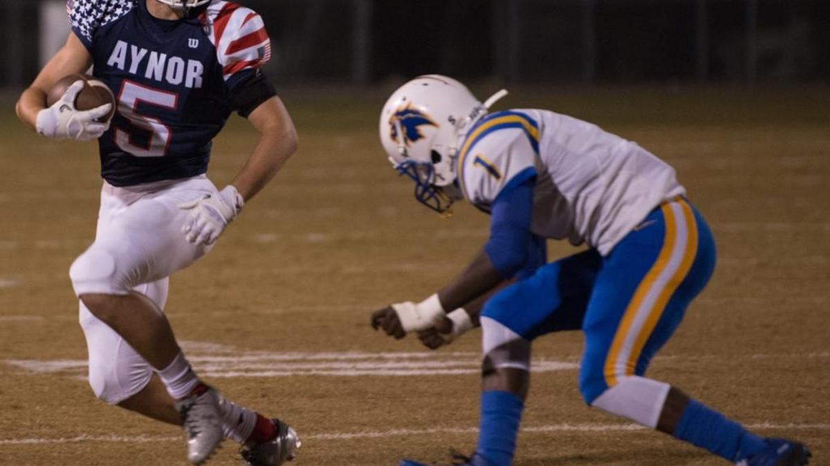 Aynor all-purpose man Caleb Jenerette tries to elude a Loris tackler during a game last season.