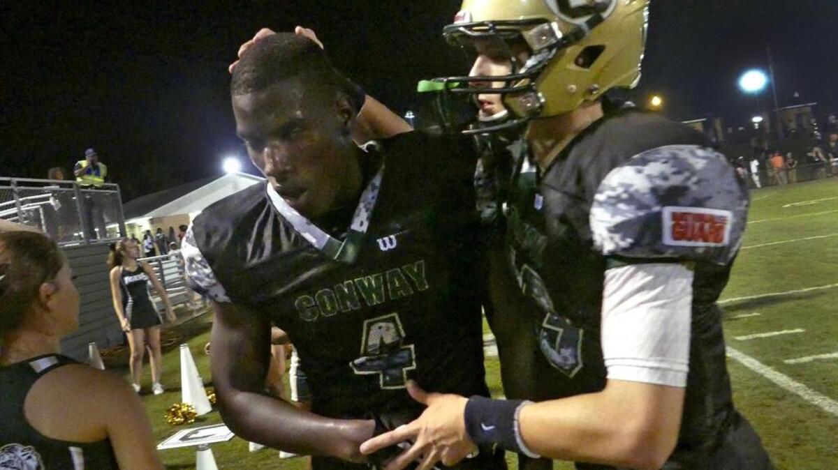 
A winded Bryan Edwards (4) is greeted by quarterback Peyton Derrick after he took a pass 74 yards for a touchdown against Hartsville.
