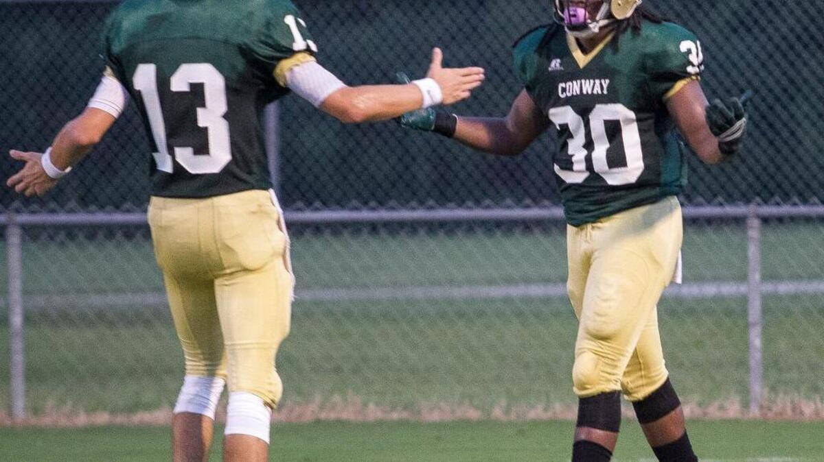 
Conway’s Peyton Derrick celebrates with Conway’s Jah-Maine Martin in  the end zone after a Martin touchdown. Conway trounced Socastee Friday night with a 43-8 final at home.
