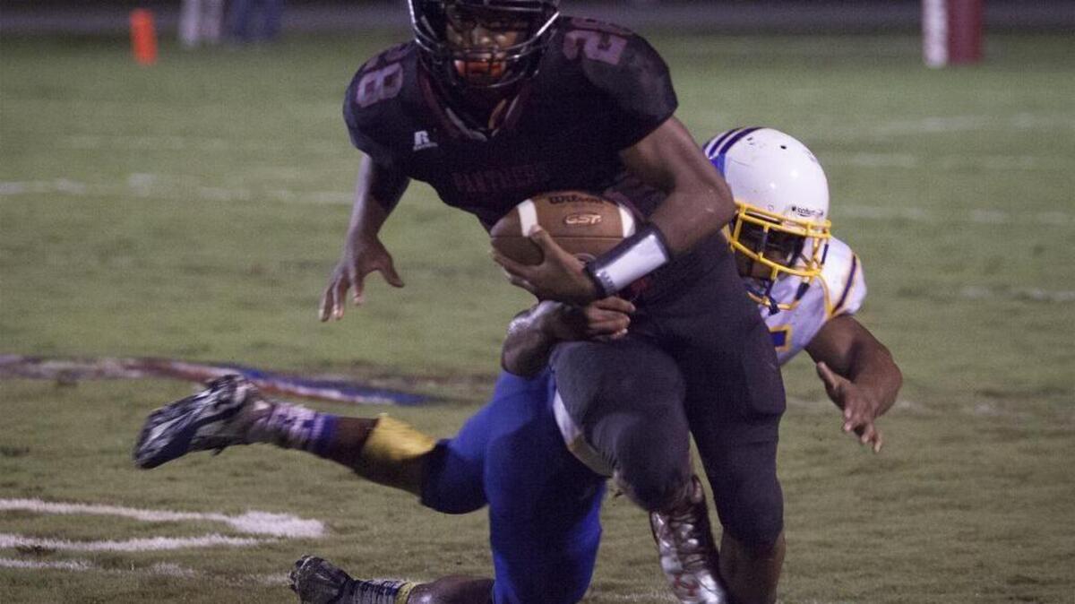 
Carolina Forest running back Dyverse Simmons (28) looks for extra yardage against North Myrtle Beach.
