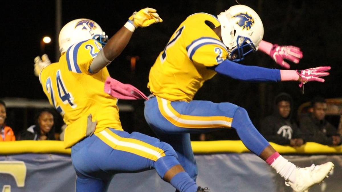 Loris’ Tyrek Williams (24) and James Walters (2) celebrate a touchdown in the Lions’ 42-14 victory over Waccamaw.