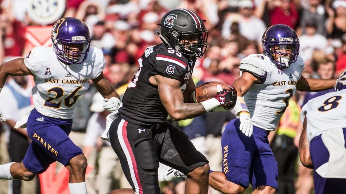 Former North Myrtle Beach standout and current East Carolina defensive back Colby Gore (left) tries to chase down South Carolina receiver and Conway alum Bryan Edwards (middle) earlier this season.