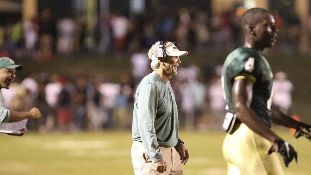 
Conway coach Chuck Jordan (center) laughs as the Tigers score off a turnover against North Myrtle Beach during the CNB Kickoff Classic.

