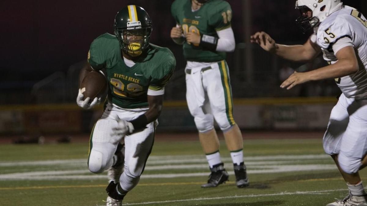 Myrtle Beach’s Jermani Green runs past Socastee’s Austin Lilly on Friday.