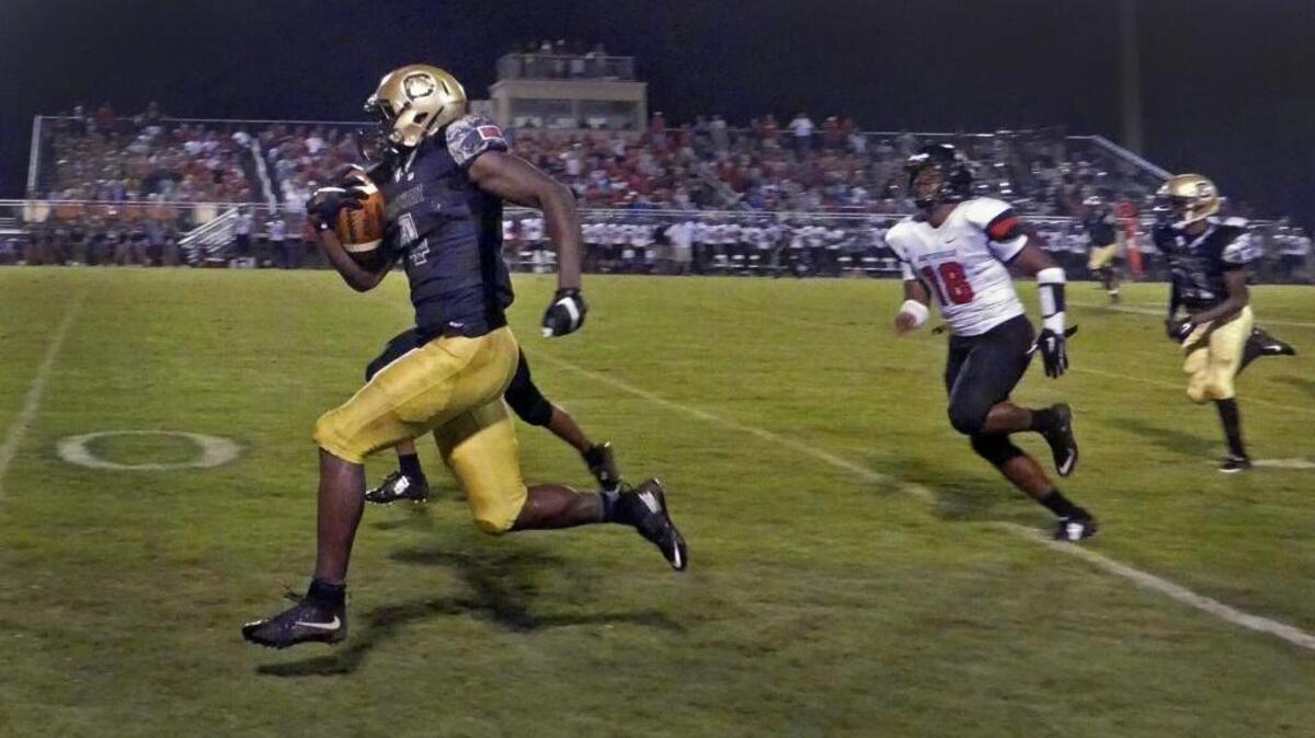 
Conway's Byran Edwards races past the Hartsville defenders for a 74-yard touchdown during the first half of their game at the Backyard in Conway.
