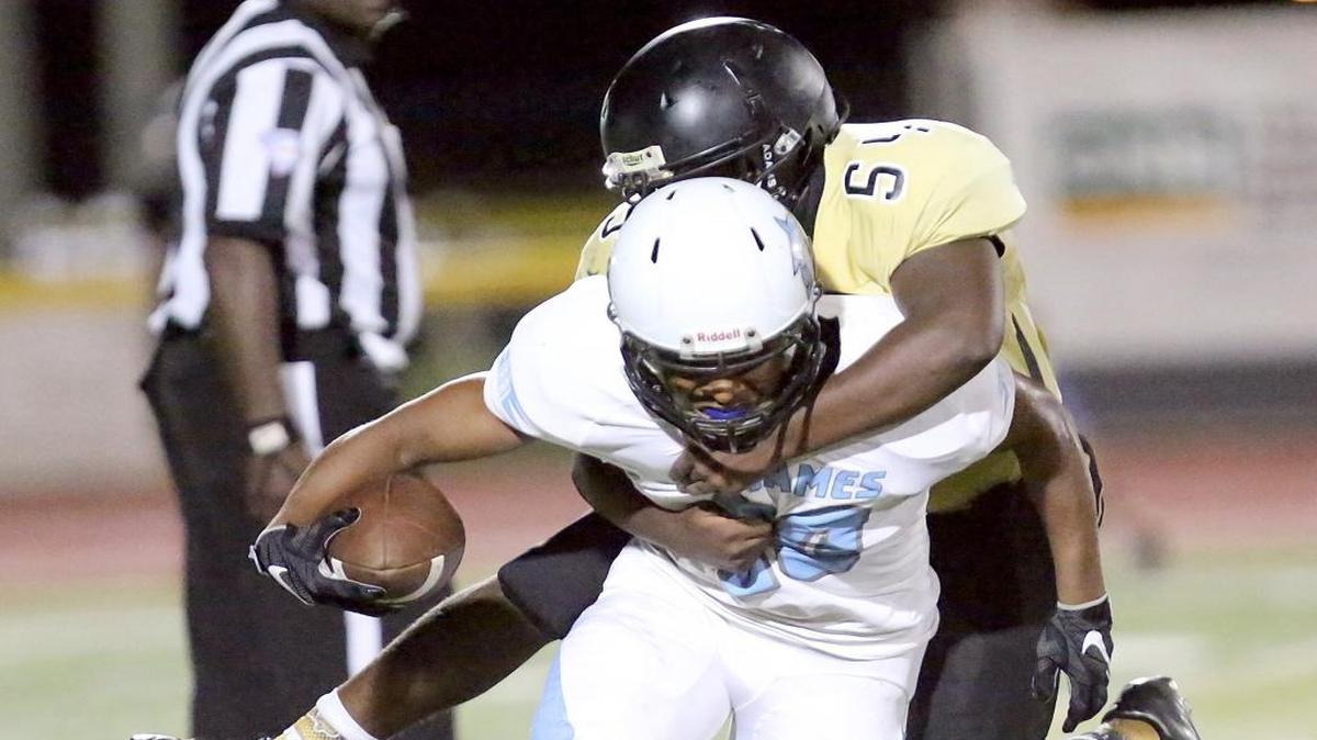 Green Sea Floyds’ Covea Ferris tries to bring down St. James’ Jay-Mion Pressley during the CNB Kickoff Classic a few weeks ago.