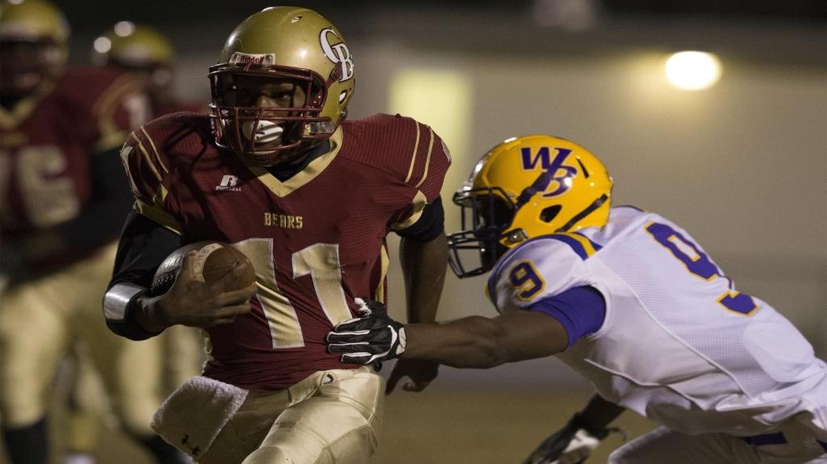 Carvers Bay quarterback Janaz Sumpter (11) runs past Whale Branch defender Amir Chisolm (9) for a first-quarter touchdown against during the second round of Class 2A playoffs Friday night.