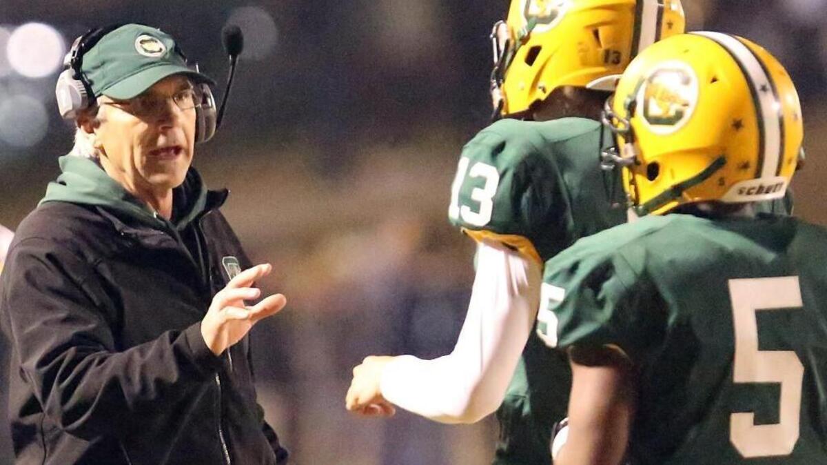 Conway football coach Chuck Jordan offers guidance to players during a game last season.