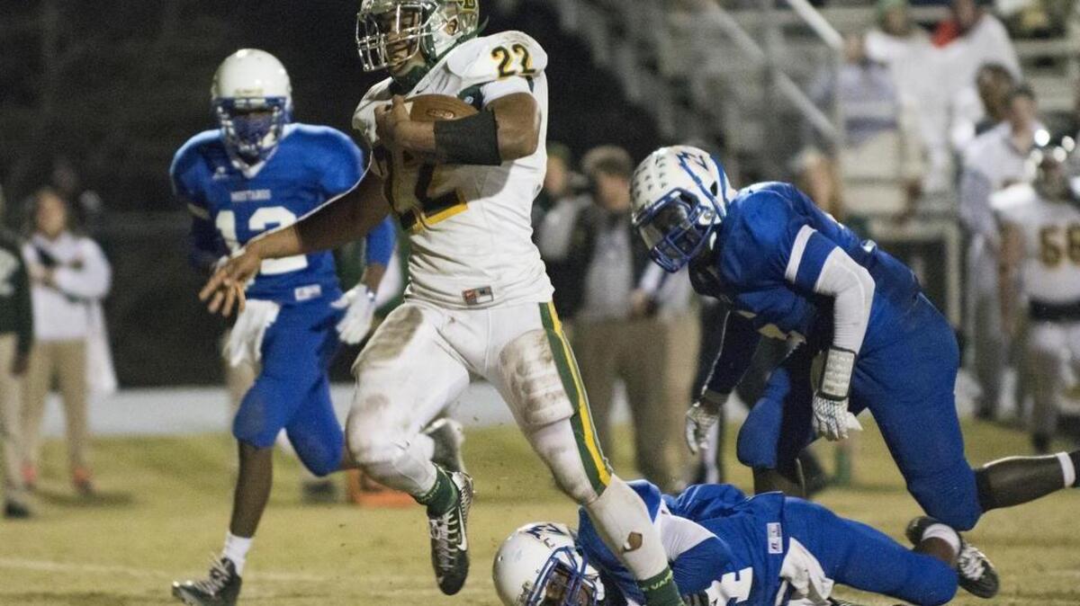 Brandon Sinclair of Myrtle Beach runs through the tackle of a Midland Valley defender en route to a touchdown during Friday’s game.