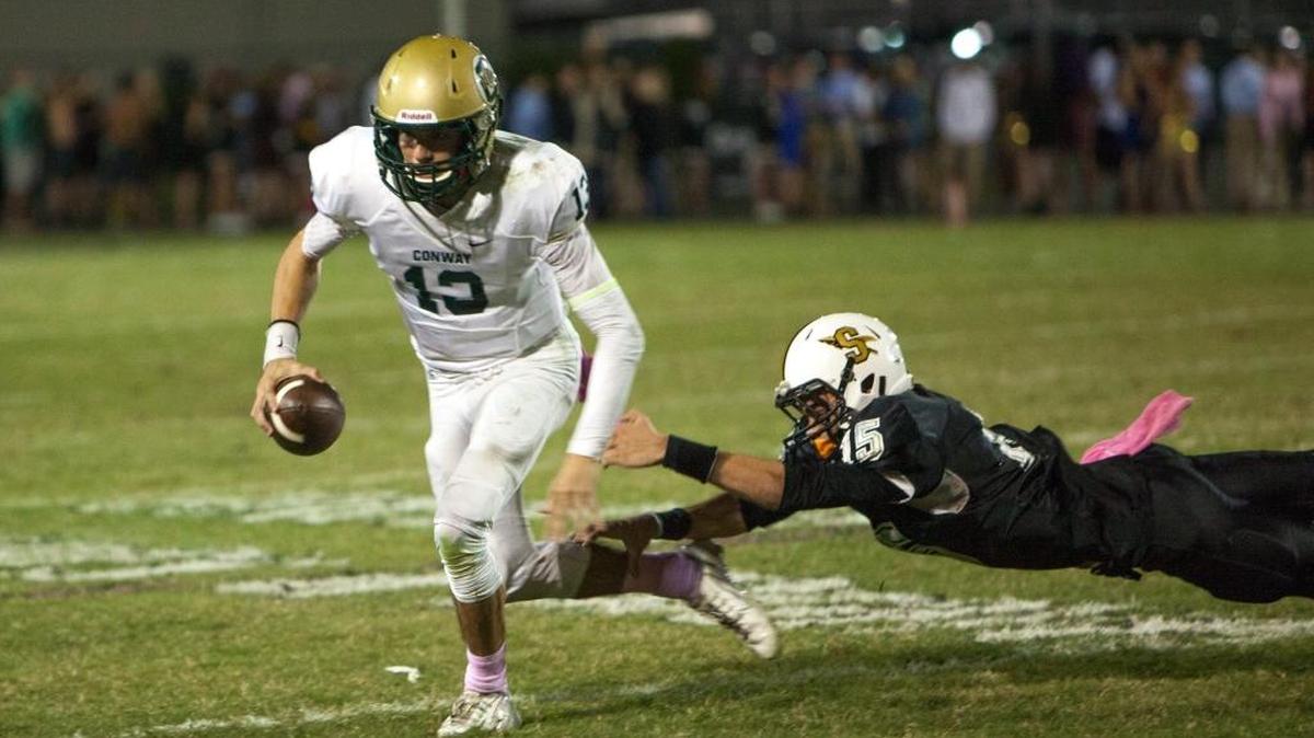
Conway’s Peyton Derrick (left) avoid a tackle attempt by Socastee’s Taylor Karnap.
