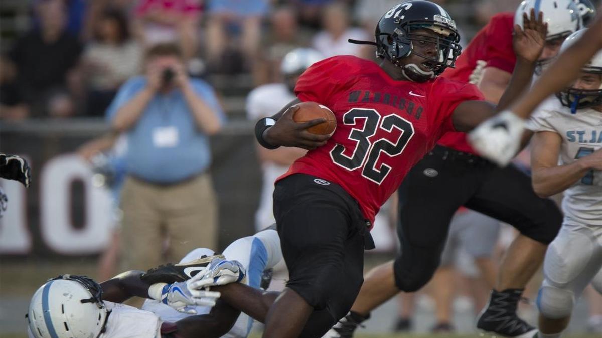 Waccamaw running back Antrix Green (32) breaks a tackle attempt by a St. James defender Friday.