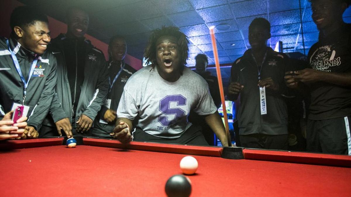 Hailing from Saluda, North offensive lineman Cortez Herrin jokes with teammates over a game of pool. Despite tight practice schedules, players are given time off the field to unwind and get to know each other.