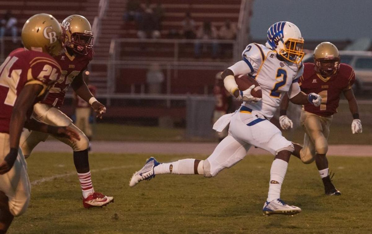 North Myrtle Beach’s Tyler Gore scurries into the end zone ahead of Carvers Bay defenders during last year’s game between the Grand Strand area powerhouses. They will meet on Friday.