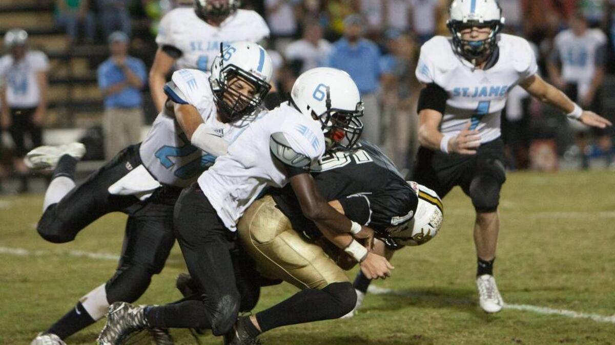 
St. James’ Jelin Bellamy (6) takes down Socastee’s Taylor Karnap during Friday’s game.
