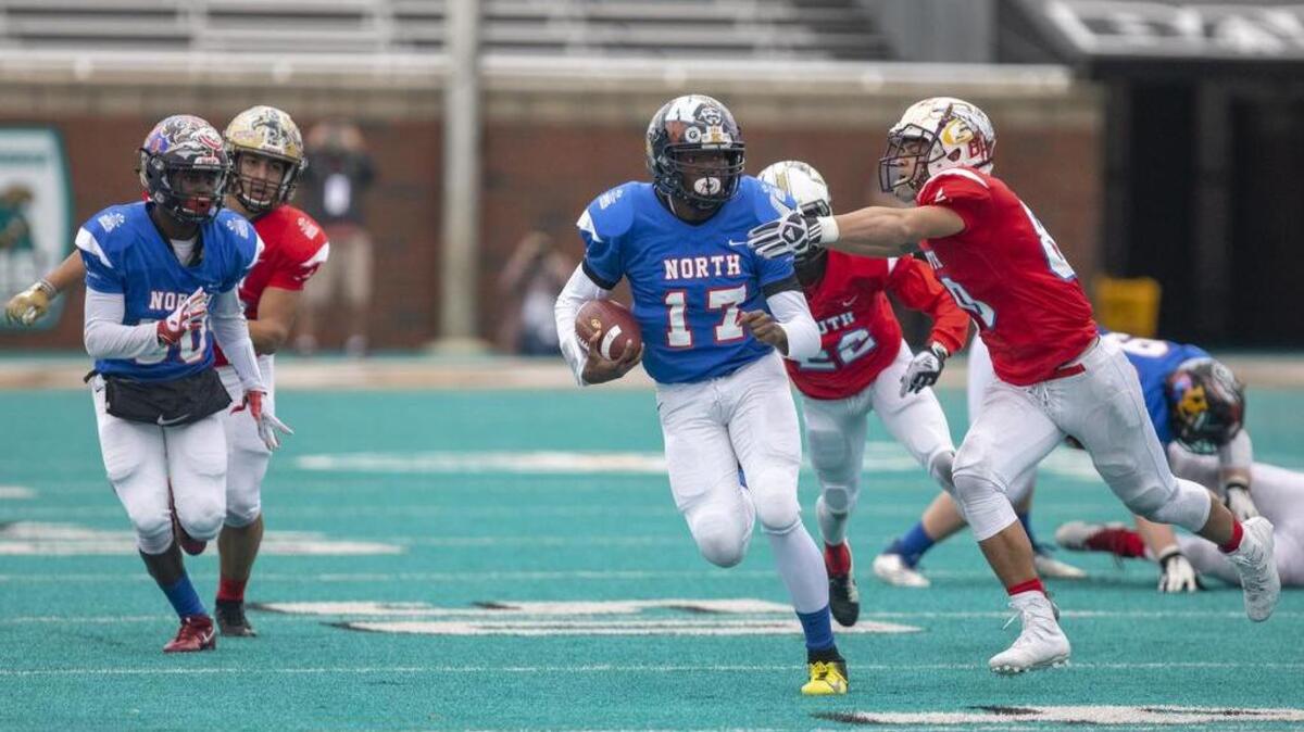 WJ Keenan senior quarterback A’lajuwan Robinson scrambles as the North All Stars take on the South All Stars in the 2018 Touchstone Energy Cooperatives North vs. South Bowl game Saturday at Brooks Stadium in Conway.