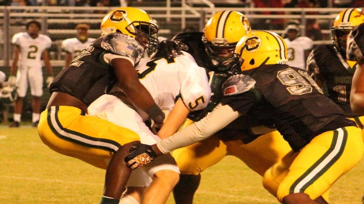 West Florence quarterback Cooper Wallace (5) is bottled up by a host of Conway defenders during the Tigers' 35-7 victory on Friday night.