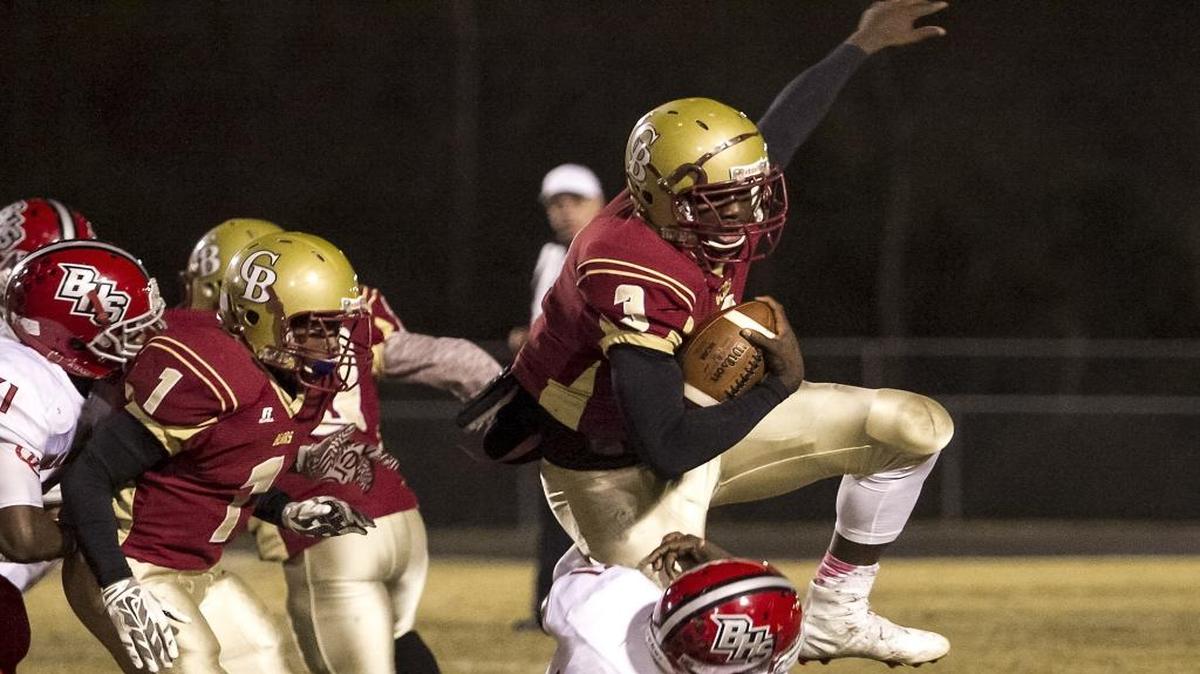 Carvers Bay’s Byron Young runs over Barnwell players during the first quarter of Friday’s game.