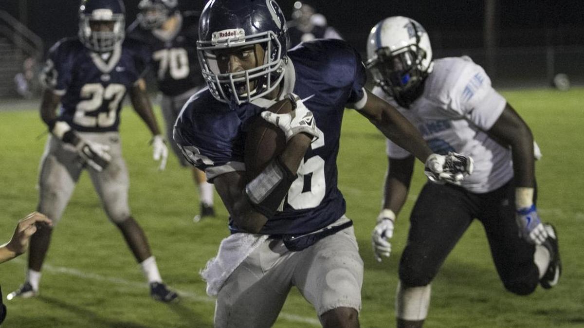 Georgetown’s LeMarkeus McCray takes the ball for a touchdown against St. James.