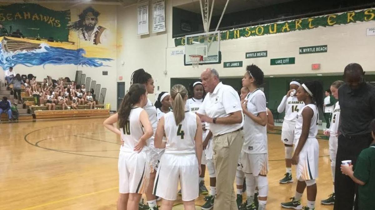 Myrtle Beach girls interim basketball coach Larry Bowen instructs his team during a timeout in the fourth quarter Friday night.