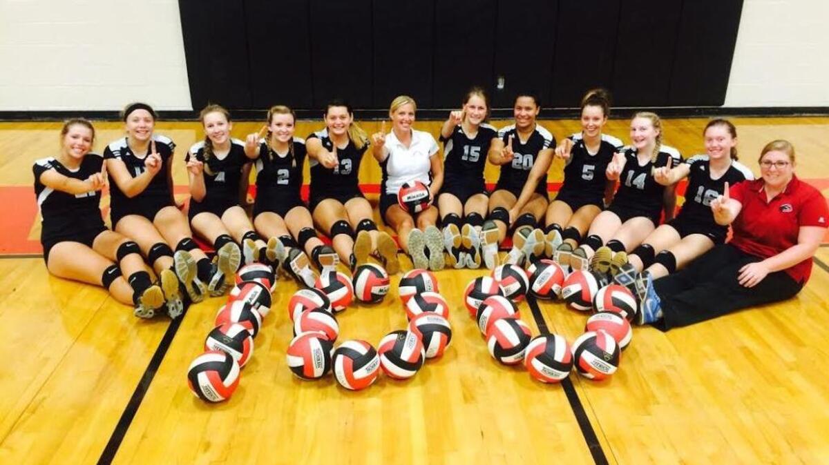 
Carolina Forest volleyball coach Brittany Drew (center) poses with her team after her 100th career coaching victory Wednesday.
