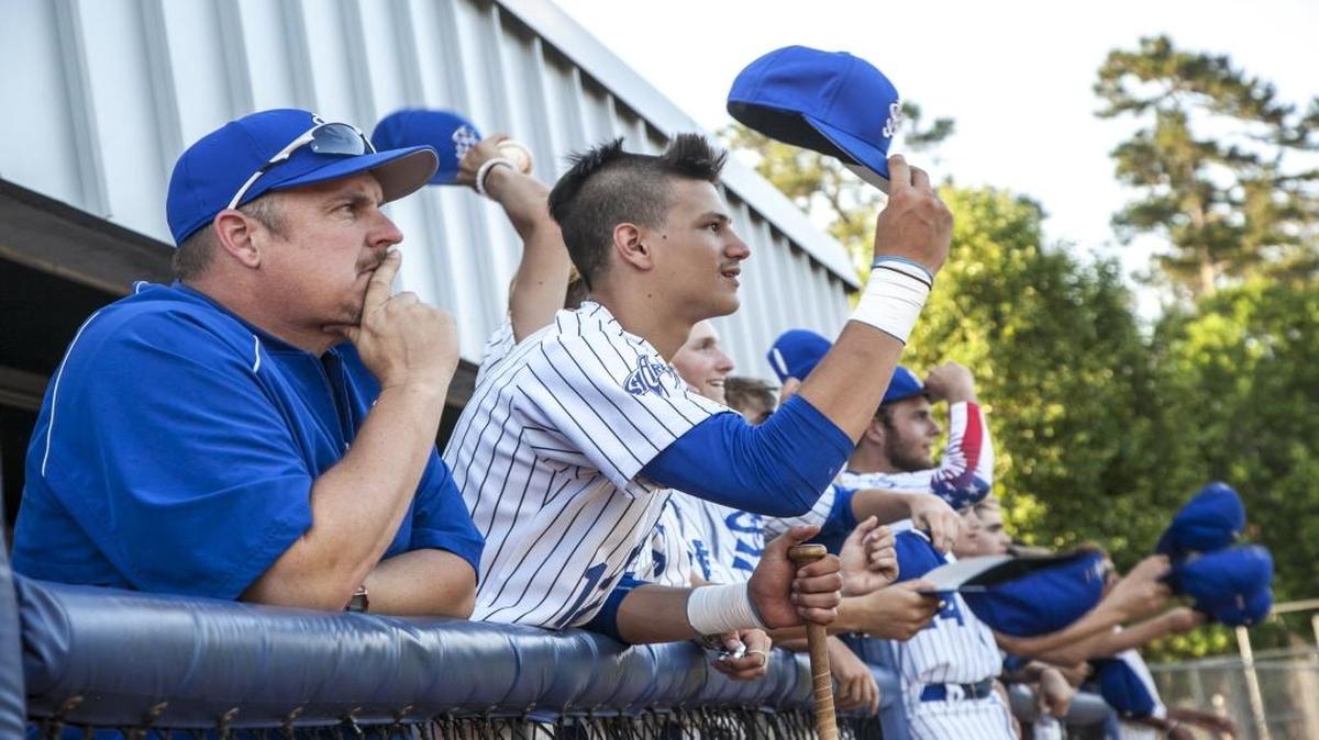 With their customary playoff haircuts, the St. James bench cheers on their teammates during a recent Lower State AAA tournament game. The Sharks will begin play in the Class AAA championship series on Thursday against Belton-Honea Path.