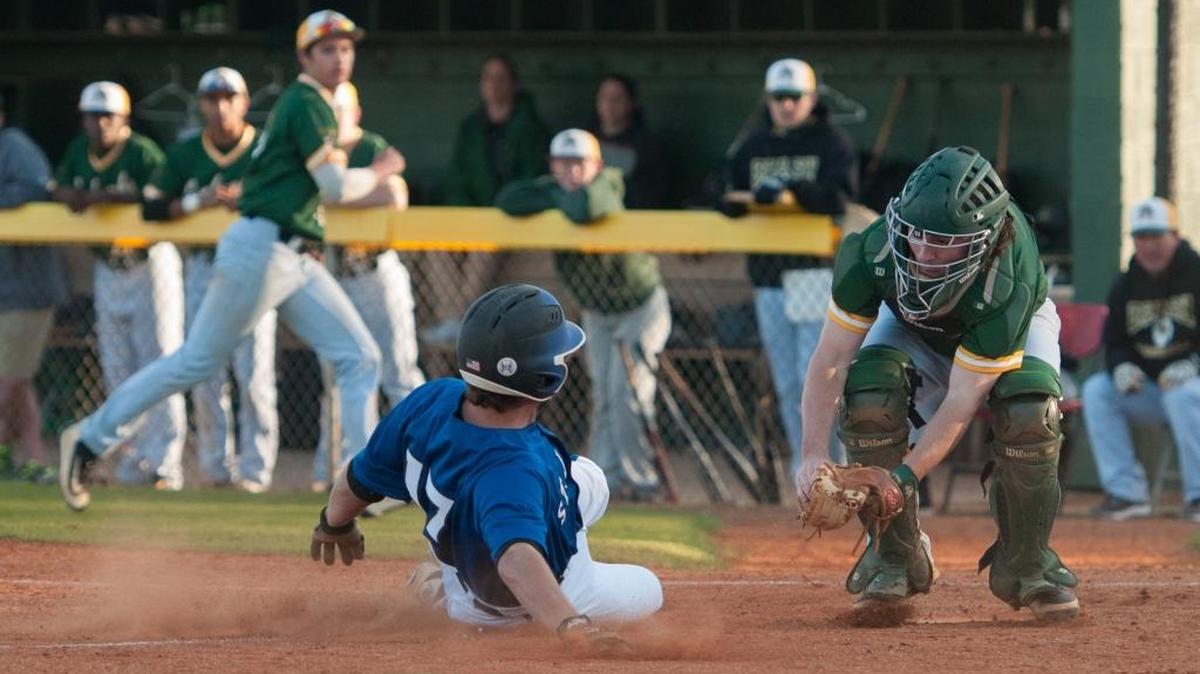 Myrtle Beach’s Chris Timmons goes for the tag as St. James’ Harrison VanLandingham slides during a game earlier this season.