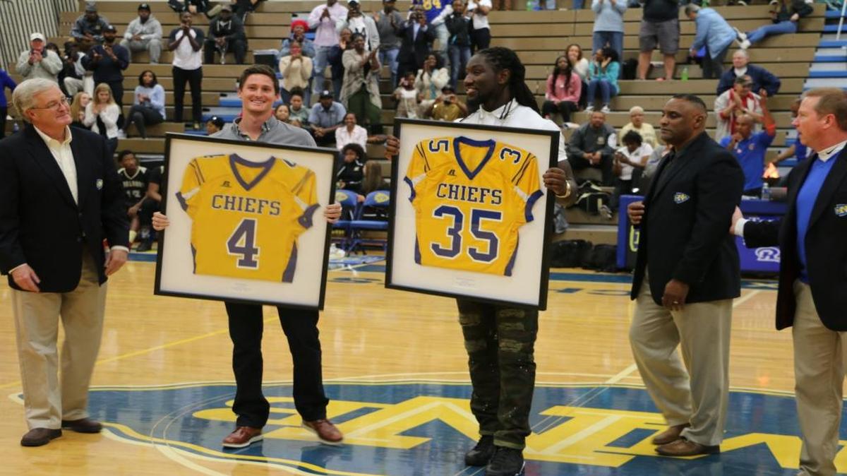 Ryan Quigley (center left) and Temmarick Hemingway (center right) were honored by North Myrtle Beach High School on Tuesday night. The first players from the school to reach the NFL, their high school jersey numbers were retired.