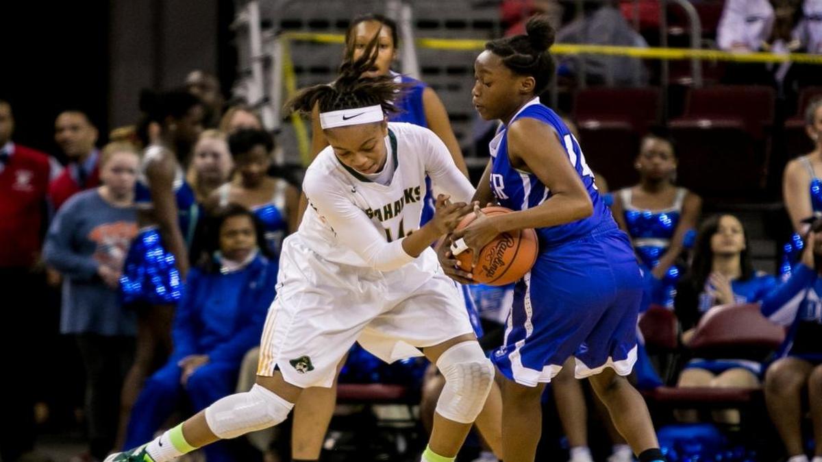 Myrtle Beach forward Nia Sumpter (left) and Dreher High School guard Eboni Jones battle for the ball during the first half of the Saturday’s Class AAA girls state title game.