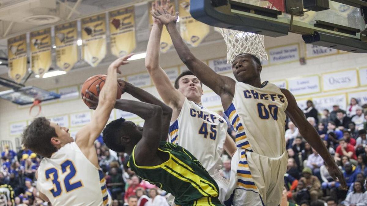 Myrtle Beach's Jaquan Chestnut gets blocked at the net by North Myrtle Beach defenders. The North Myrtle Beach Chiefs host the Myrtle Beach Seahawks in varsity basketball on Thursday night. Feb. 11, 2016.