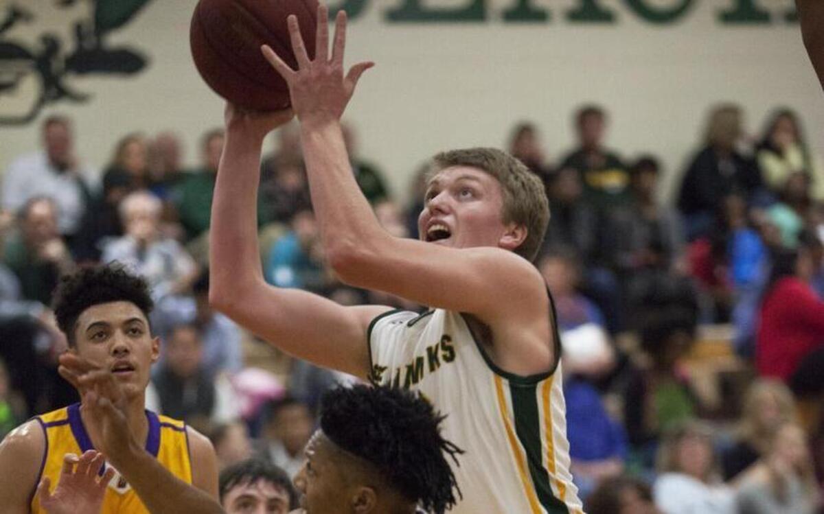 Myrtle Beach forward Ben Mintz (20) takes the ball to the basket against Wilson's Joseph Holloman (5) during 1st half action Friday night at Myrtle Beach High School.