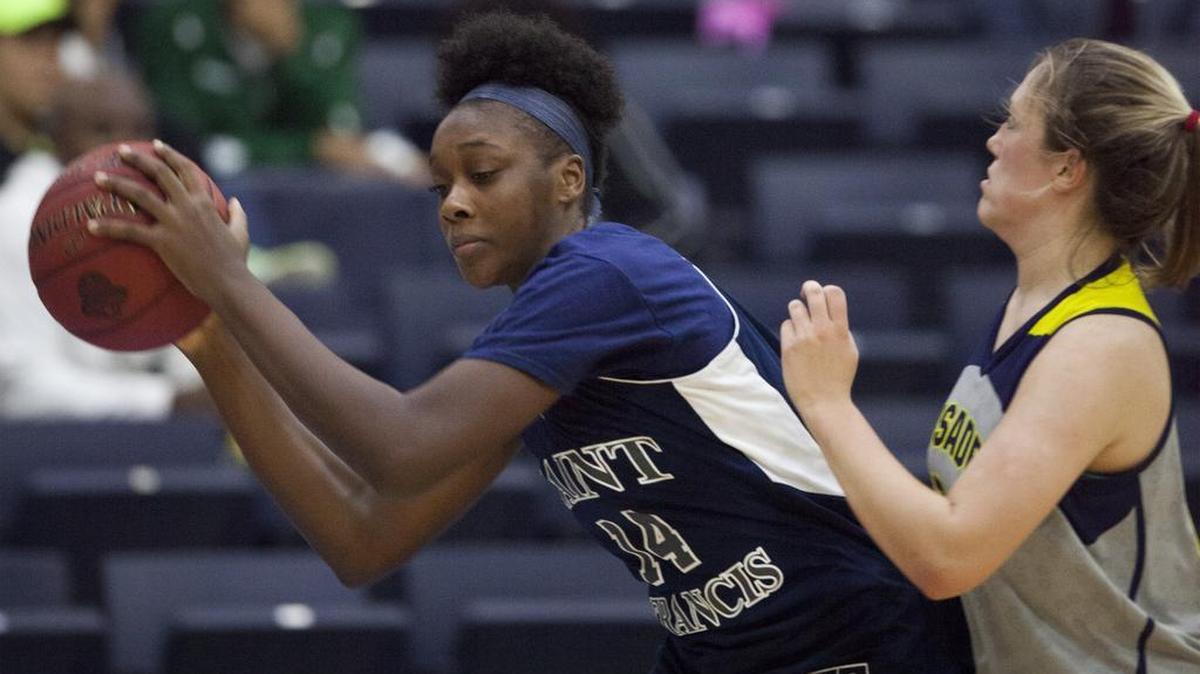 St. Francis’ Jala Jordan (14) tries to evade a St. Mary’s defender during Monday’s game.