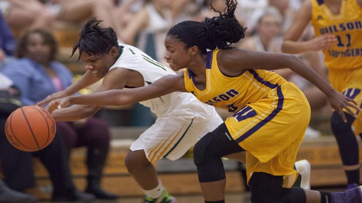 Myrtle Beach guard Keocia Walker (11) and Wilson guard Casma Washington (13) go for a loose ball during the second of three games between the Seahawks and Tigers, respectively. The Region VII-4A rivals will meet in Florence on Friday to begin league play.
