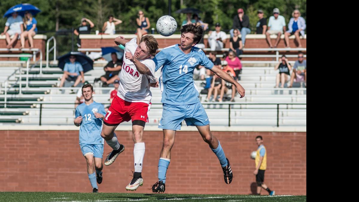 
St. James’ Joey Simpson (14) battles an A.C. Flora player for the ball during Saturday’s Class AAA state championship match.
