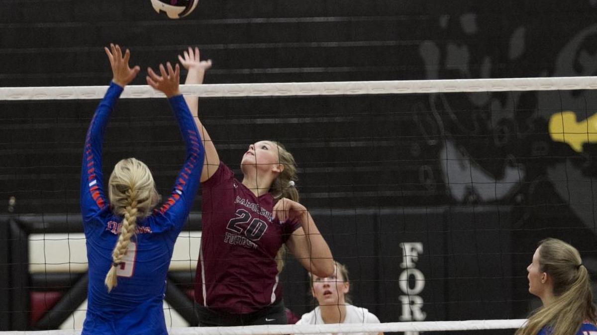 Carolina Forest’s Kaitlyn Andresen tries to send a ball past the outstretched arms of a James Island player during the first round of last year’s Class 5A volleyball playoffs.