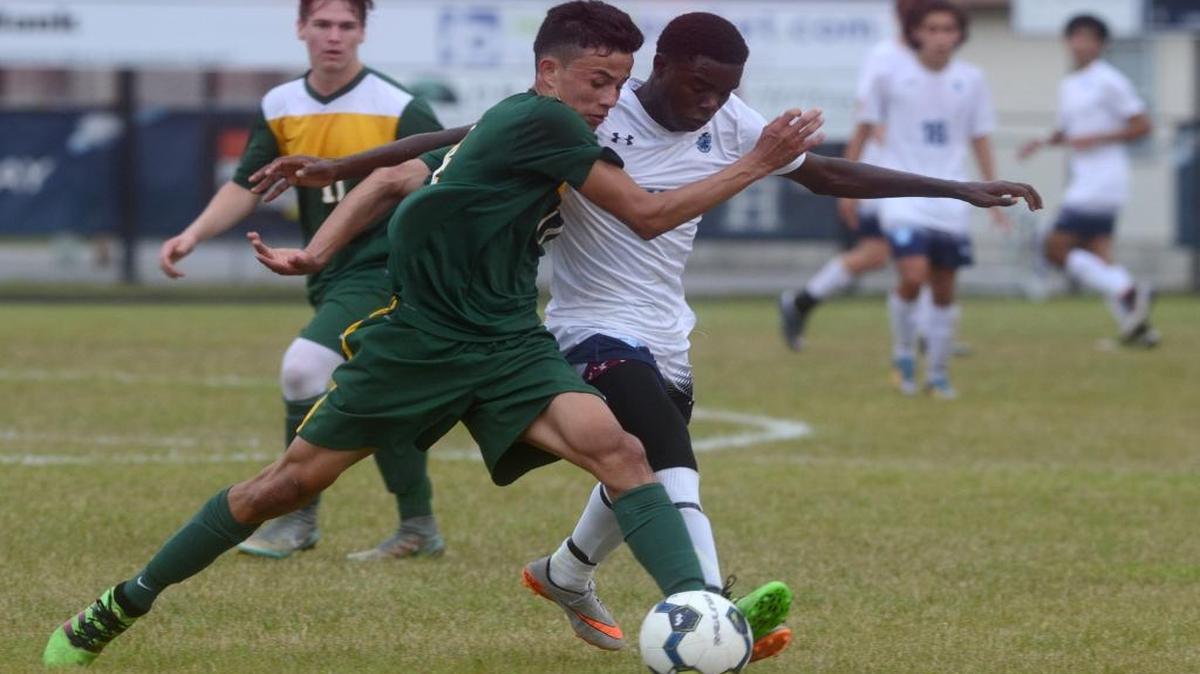 Hilton Head Island’s Garvin Richards and Myrtle Beach’s Lenin Molina fight for the ball during the first half of the Class AAA Lower State boys’ soccer final on Tuesday.