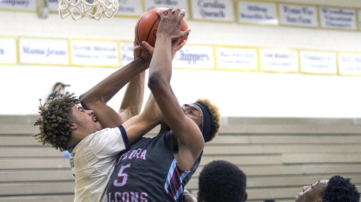 Millbrook’s Jordan Whitfield (left) battles A.C. Flora’s Deshawn Thomas for a rebound during Thursday’s championship game of the Shootout by the Sea tournament.