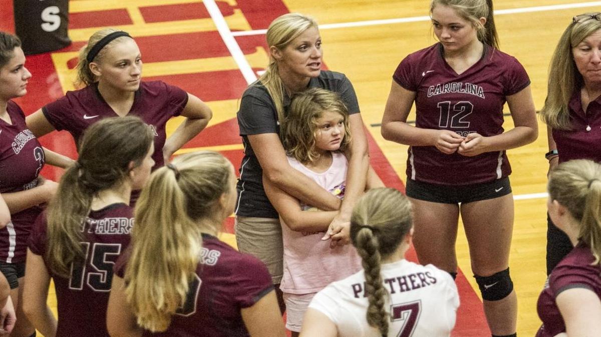 Carolina Forest coach Brittany Drew hugs her daughter, Olivia, during a postgame chat with her team this past season.