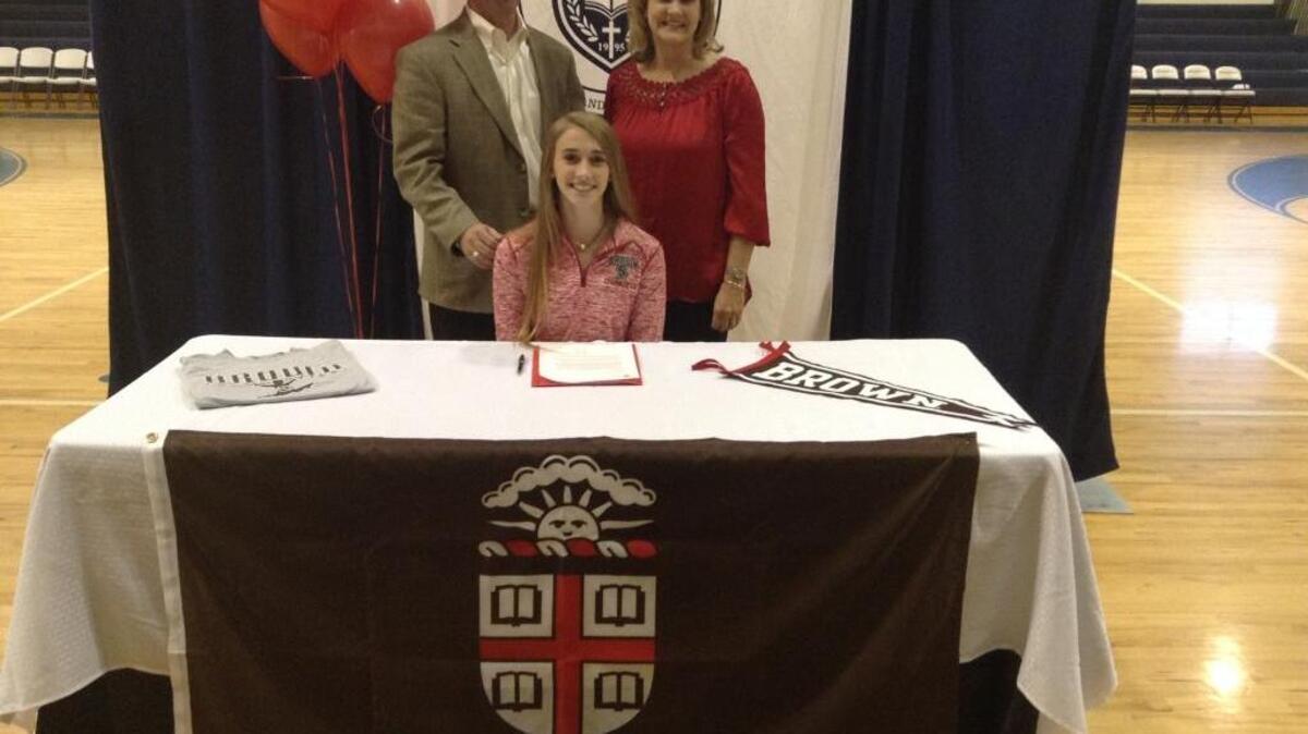 Lowcountry Preparatory School’s Caroline Warren poses with her parents last week after signing on to become a member of the Brown University gymnastics team.