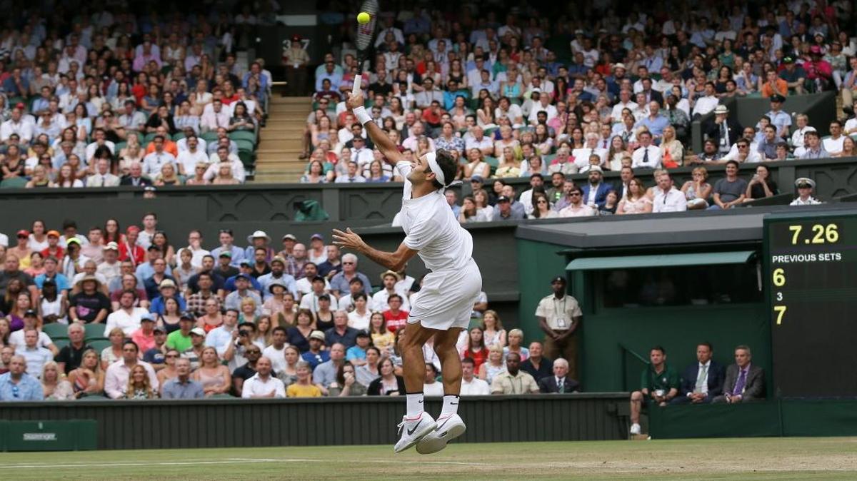 Switzerland's Roger Federer returns to Germany's Mischa Zverev during their Men's singles match on day six at the Wimbledon Tennis Championships.