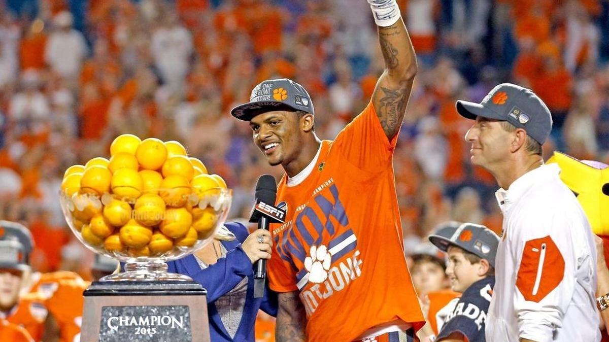 Clemson quarterback and Offensive MVP Deshaun Watson, middle, and head coach Dabo Swinney, right, celebrate after defeating Oklahoma, 37-17, in the Capital One Orange Bowl at SunLife Stadium in Miami Gardens, Fla.