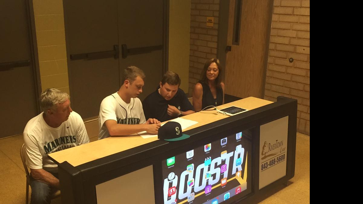 
Left to right: Father Michael Thompson, Dylan Thompson, Mariners scout Joe Barbera and Nancy Thompson as Dylan signs his MLB contract at Socastee High School. 
