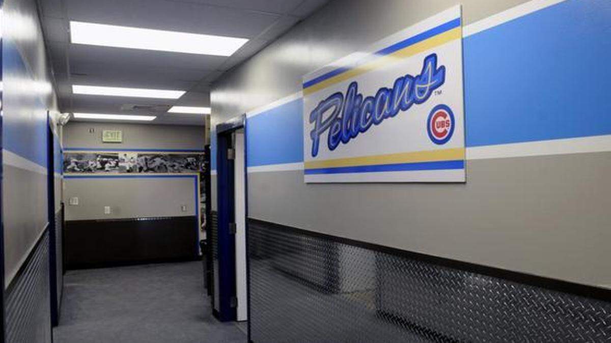 Cubs photos along the wall and the Pelicans banner and shiny chrome plate wainscoting make a sharp looking hallway from the locker room to the coaches offices.